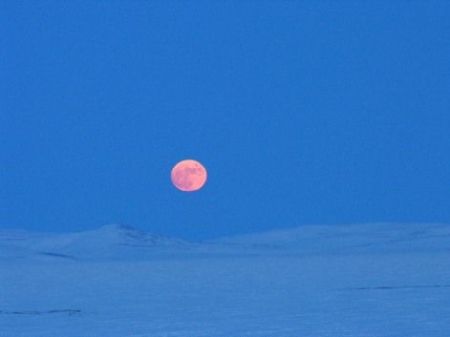 A fat moon climbs over Lake El’gygytgyn in northeast Russia.